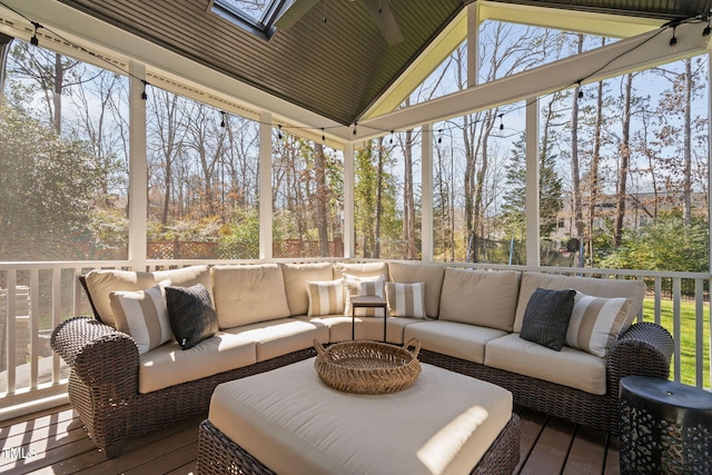 sunroom / solarium with lofted ceiling with skylight