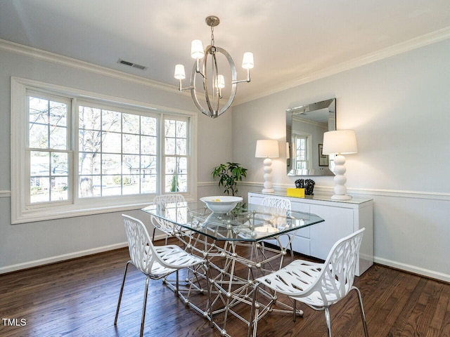 dining area featuring a chandelier, visible vents, crown molding, and wood finished floors