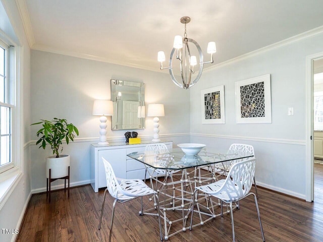 dining room with baseboards, crown molding, an inviting chandelier, and wood finished floors