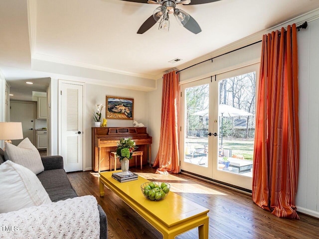 living room featuring visible vents, wood finished floors, french doors, and ornamental molding