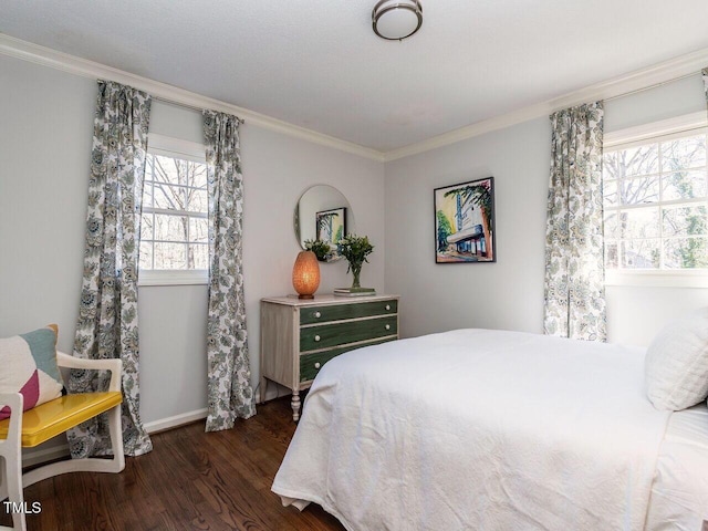 bedroom featuring crown molding, baseboards, and dark wood-type flooring