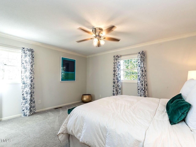 carpeted bedroom with crown molding, visible vents, and baseboards