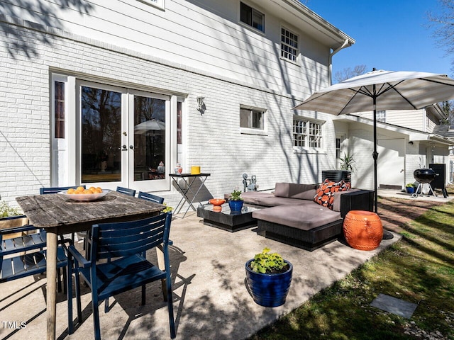 view of patio with a grill, outdoor dining area, french doors, and an outdoor hangout area