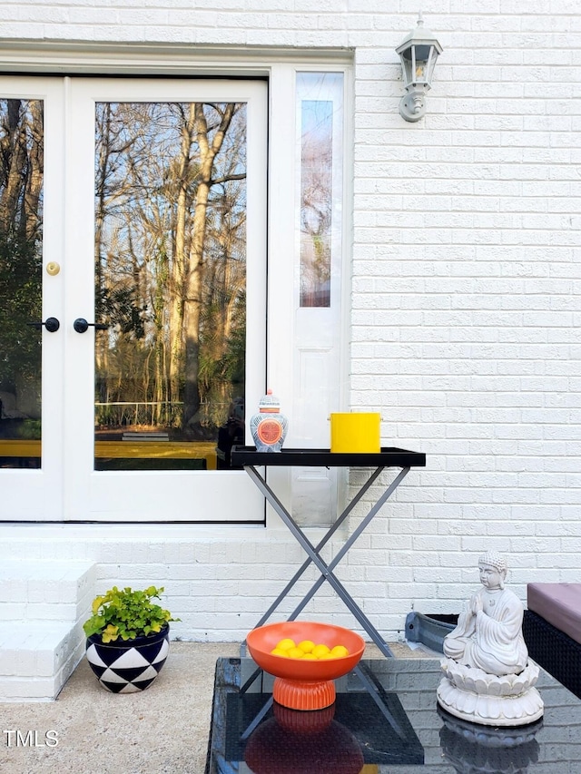 exterior details featuring brick siding and french doors