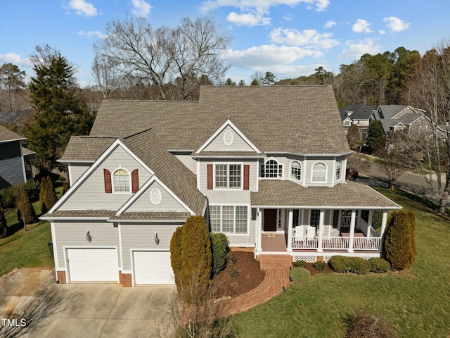 view of front of home featuring a porch, concrete driveway, an attached garage, and a shingled roof