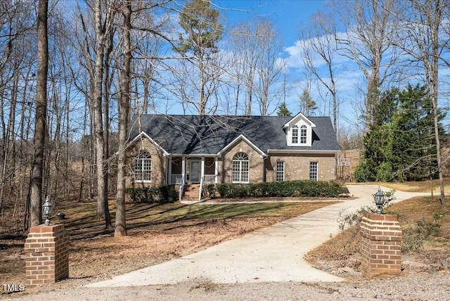 cape cod home with brick siding