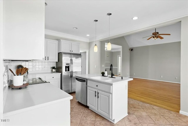 kitchen featuring decorative backsplash, light countertops, light tile patterned floors, and stainless steel appliances