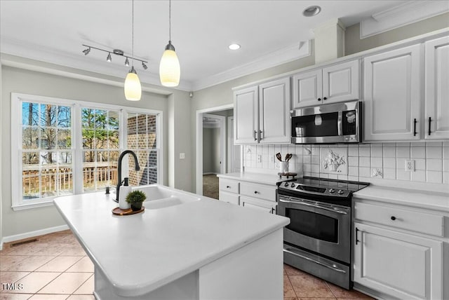 kitchen with a sink, stainless steel appliances, decorative backsplash, and light countertops