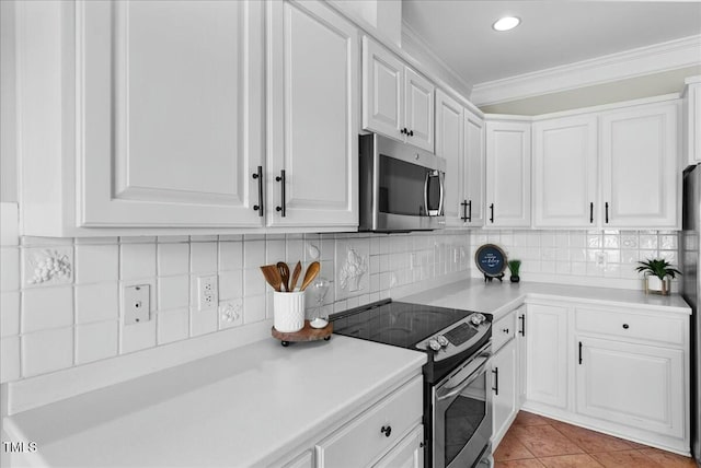 kitchen featuring stainless steel appliances, decorative backsplash, light countertops, white cabinetry, and crown molding