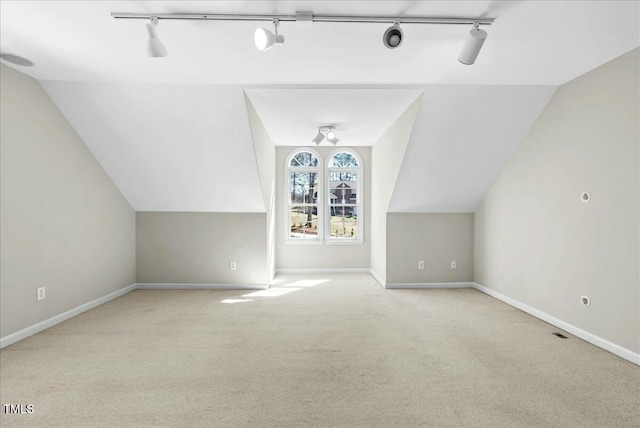 bonus room featuring baseboards, carpet, and vaulted ceiling