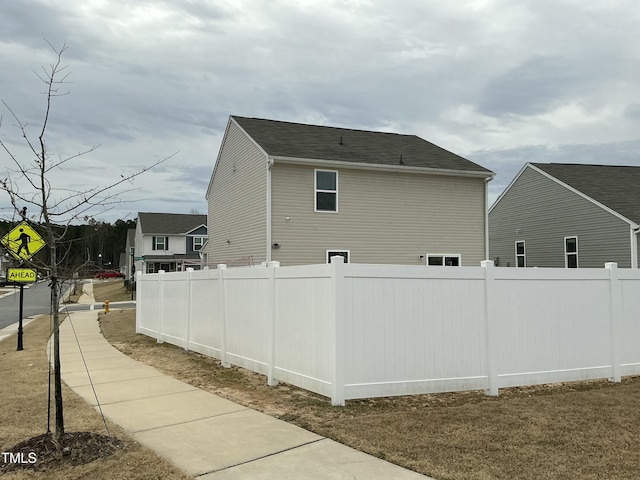 view of home's exterior featuring fence