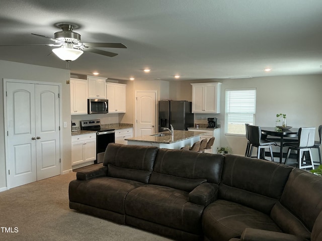 living area with recessed lighting, carpet floors, and ceiling fan