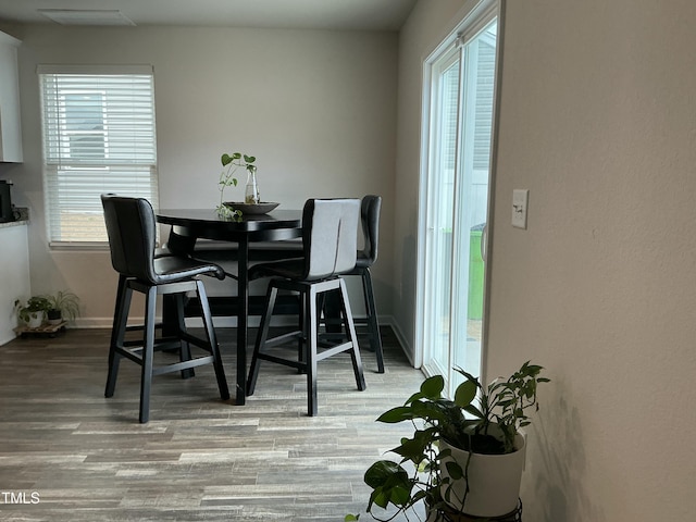 dining room featuring baseboards and wood finished floors