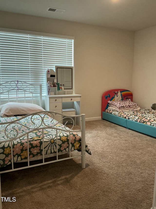 carpeted bedroom with visible vents and baseboards