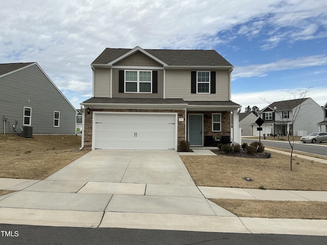 view of front facade with central air condition unit, stone siding, an attached garage, and driveway