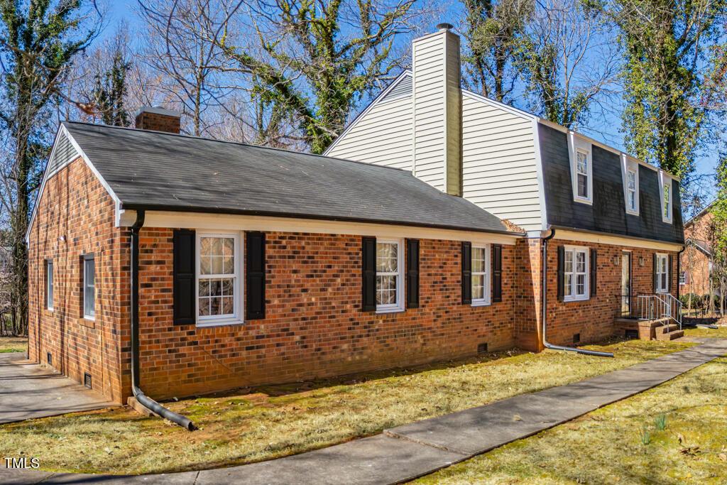 350 W Lake Trl, Mebane, NC 27302 - view of side of home featuring a shingled roof, a yard, brick siding, and a chimney