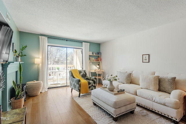 living room featuring a textured ceiling and wood finished floors