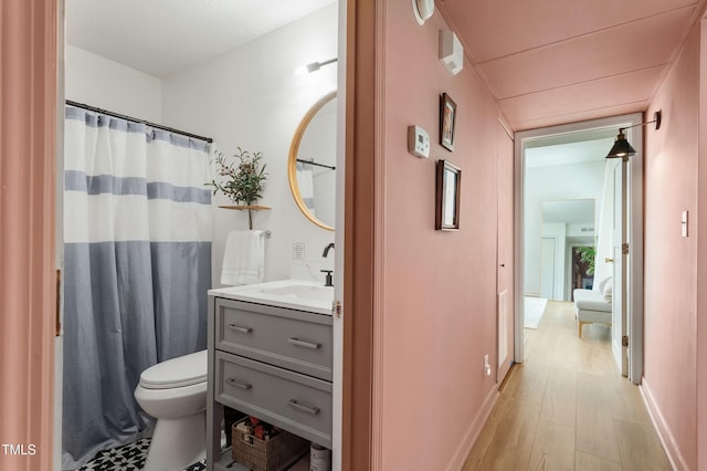 full bath featuring vanity, wood finished floors, toilet, and a shower with curtain