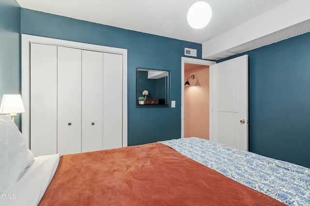 unfurnished bedroom featuring a closet and visible vents