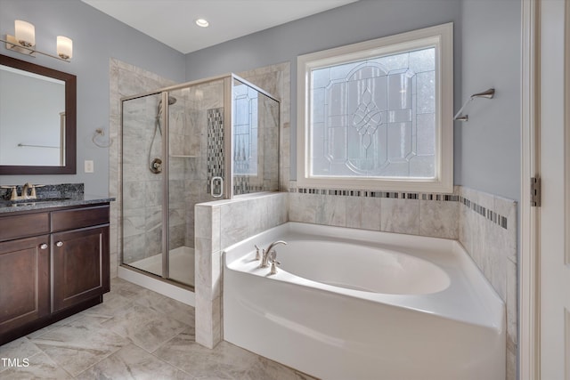 bathroom featuring a wealth of natural light, a garden tub, a stall shower, and vanity