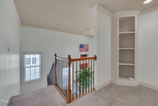 stairway with carpet flooring, crown molding, baseboards, and built in features