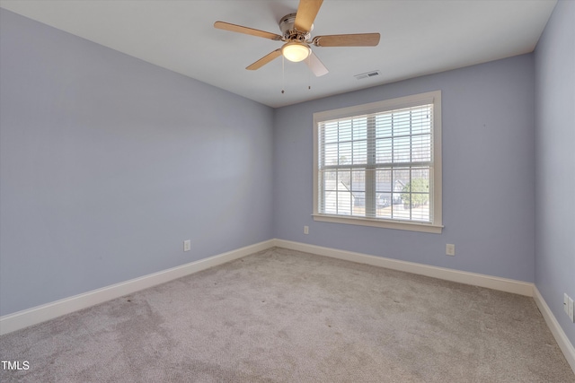 spare room featuring visible vents, baseboards, carpet, and a ceiling fan