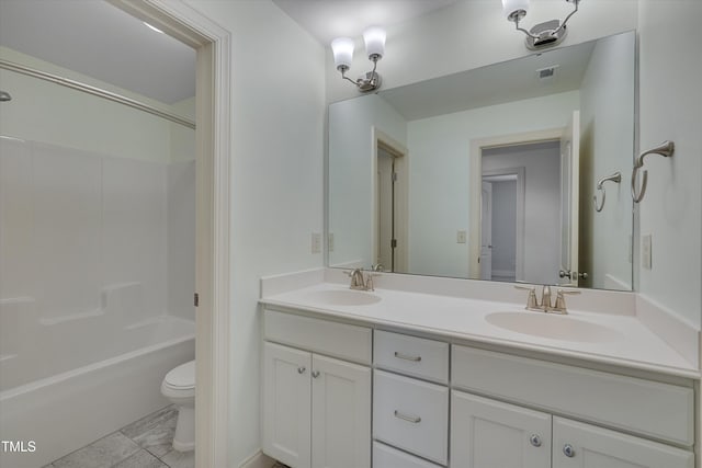 bathroom featuring a sink, toilet,  shower combination, and double vanity