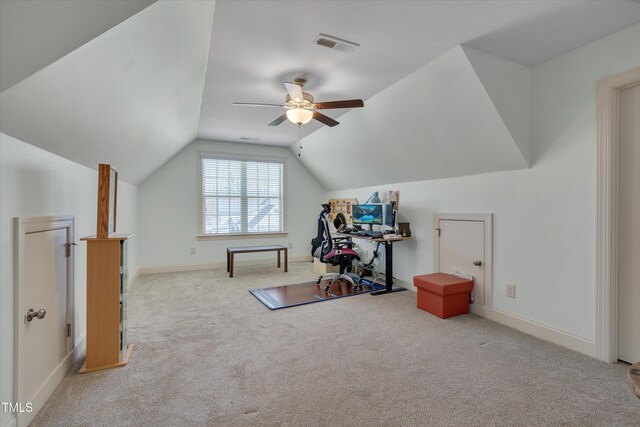 interior space with vaulted ceiling, a ceiling fan, baseboards, and carpet floors