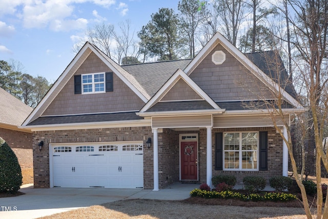 view of front of property with brick siding, an attached garage, driveway, and a shingled roof