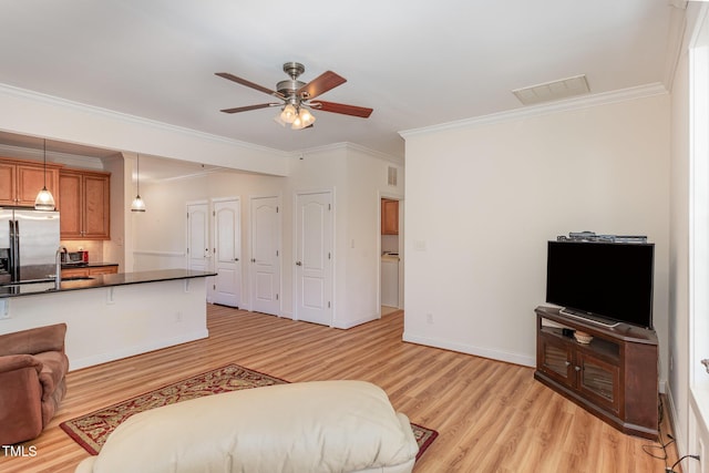 interior space featuring visible vents, crown molding, baseboards, ceiling fan, and light wood-style flooring