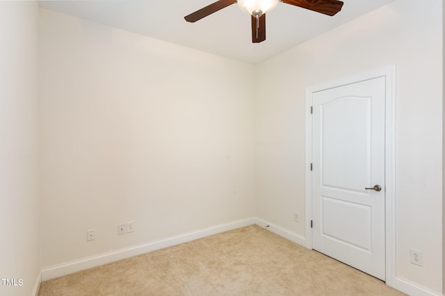 empty room with light colored carpet, baseboards, and ceiling fan