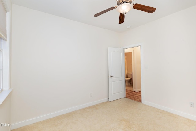 unfurnished room featuring carpet flooring, baseboards, and ceiling fan