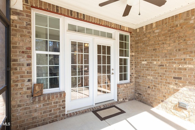 property entrance with ceiling fan, french doors, brick siding, and crawl space