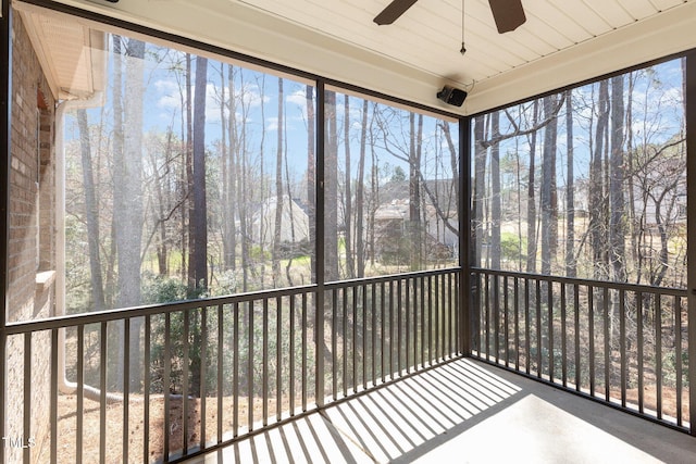 unfurnished sunroom with plenty of natural light and ceiling fan