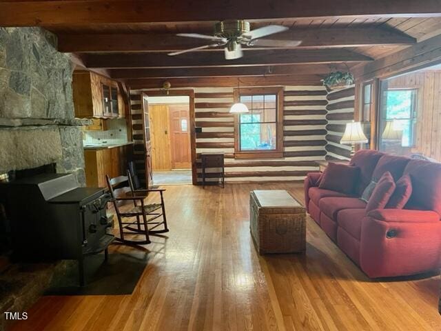 182 Tree Cutters, Sanford, NC 27332 - living area with wood walls, beam ceiling, wood-type flooring, ceiling fan, and a fireplace