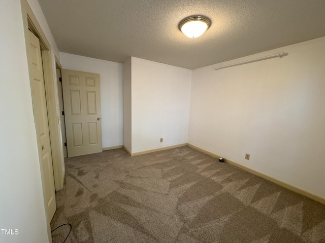 unfurnished bedroom with baseboards, carpet, and a textured ceiling