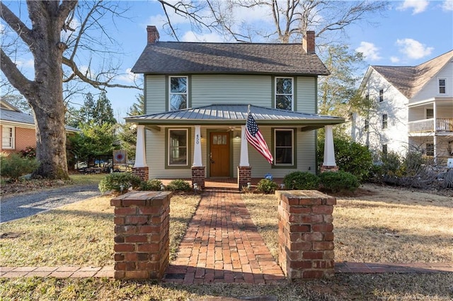 view of front of home with a porch and a chimney