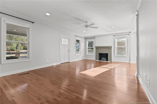 unfurnished living room featuring hardwood / wood-style floors, plenty of natural light, and a fireplace