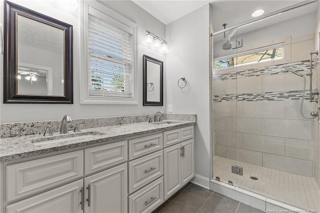 bathroom featuring a wealth of natural light, tile patterned floors, and a sink