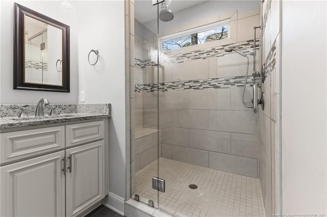 full bathroom featuring vanity and a shower stall