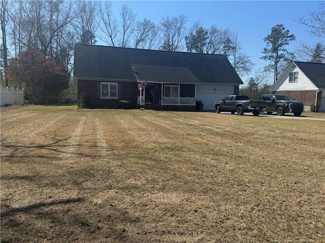 view of front of property with a garage, a front yard, and fence