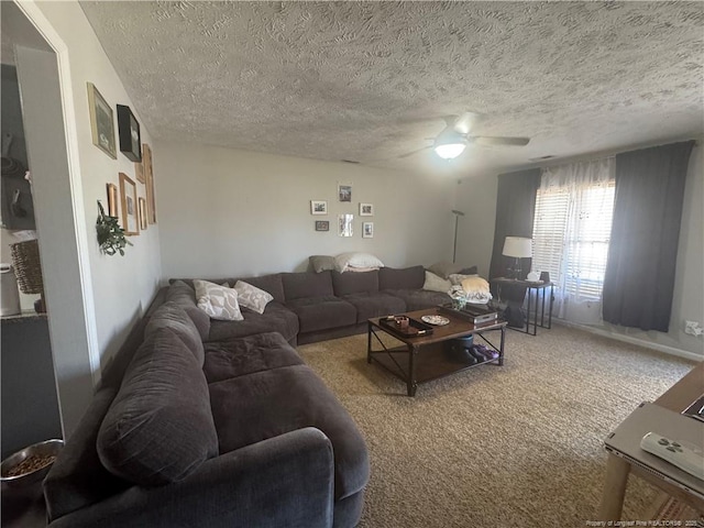 living room with baseboards, carpet flooring, a textured ceiling, and a ceiling fan