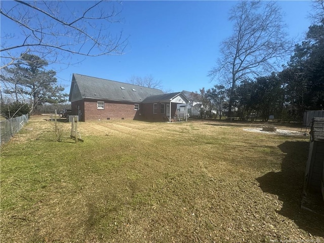 view of yard featuring a fire pit and fence