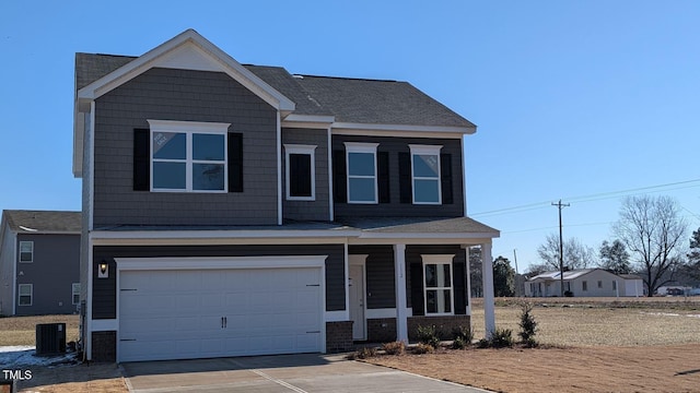 craftsman inspired home with concrete driveway, a porch, central AC unit, and a garage