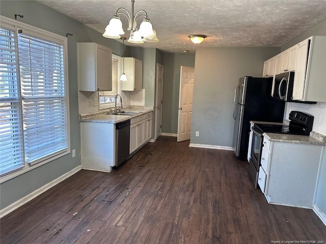 kitchen with baseboards, a sink, dark wood-type flooring, appliances with stainless steel finishes, and white cabinetry