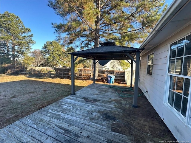 wooden deck with a gazebo, a yard, and a fenced backyard