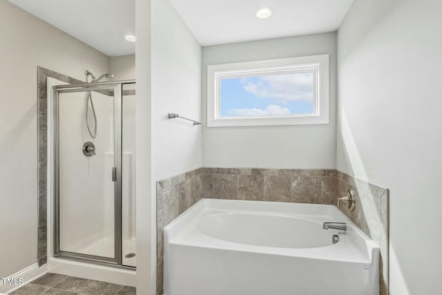 bathroom with a garden tub and a stall shower