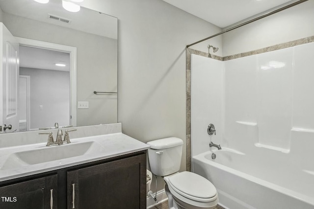 full bathroom featuring visible vents, toilet, vanity, and shower / tub combination