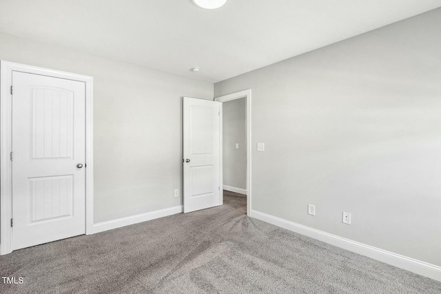 unfurnished bedroom featuring baseboards and carpet