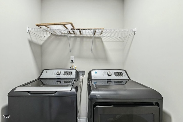 laundry room with washer and dryer and laundry area